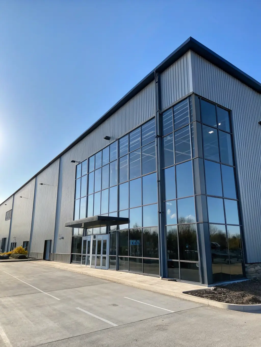 A detailed close-up of a steel warehouse structure, highlighting the robust framework, bolted connections, and durable cladding materials used in its construction.